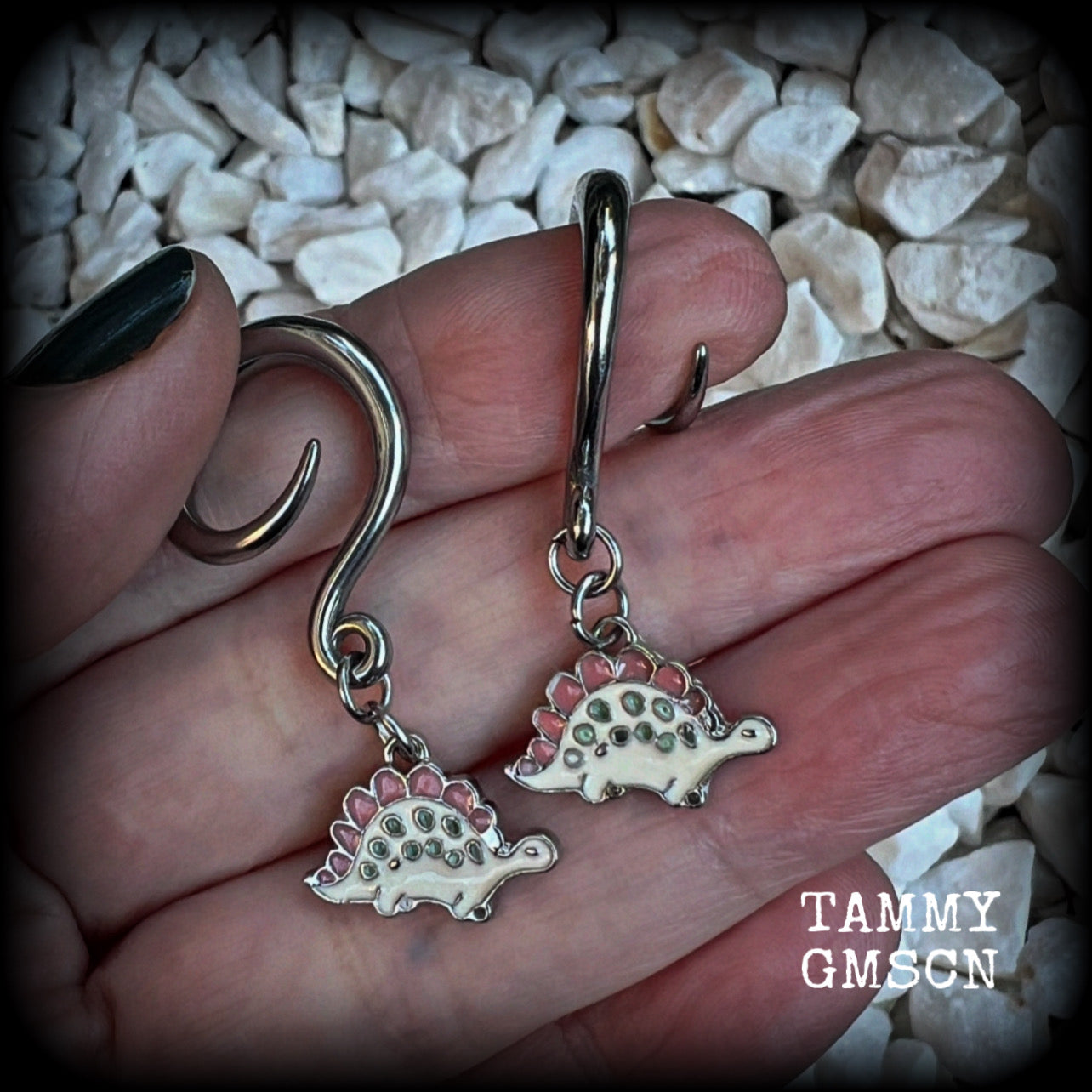 These adorable pink and white enamel stegosaurus gauged earrings are nice and light weight at approx 5 grams a piece, and nice and dangly at just under 5cms from tip to tip.

This pair has been made on 6 gauge (4mm) surgical steel full curl hooks, to be worn in stretched lobes.