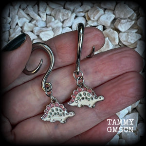 These adorable pink and white enamel stegosaurus gauged earrings are nice and light weight at approx 5 grams a piece, and nice and dangly at just under 5cms from tip to tip.

This pair has been made on 6 gauge (4mm) surgical steel full curl hooks, to be worn in stretched lobes.