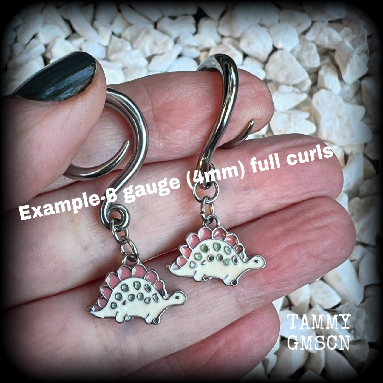 These adorable pink and white enamel stegosaurus gauged earrings are nice and light weight at approx 5 grams a piece, and nice and dangly at just under 5cms from tip to tip.

This pair has been made on 6 gauge (4mm) surgical steel full curl hooks, to be worn in stretched lobes.