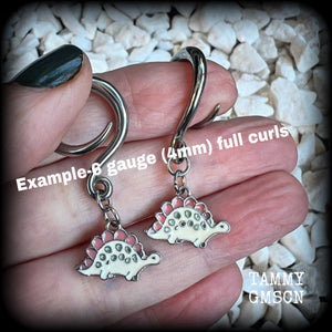 These adorable pink and white enamel stegosaurus gauged earrings are nice and light weight at approx 5 grams a piece, and nice and dangly at just under 5cms from tip to tip.

This pair has been made on 6 gauge (4mm) surgical steel full curl hooks, to be worn in stretched lobes.