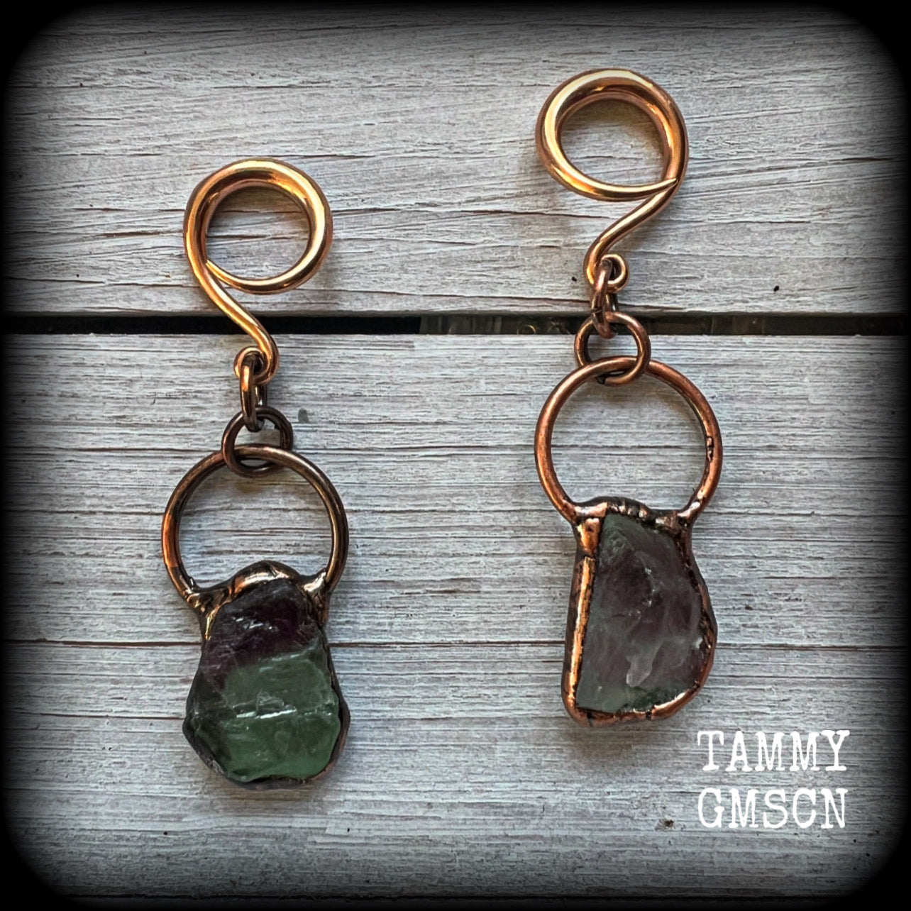 Featuring gorgeous unique fluorite gemstones in an antique copper setting, these gauged earrings measure approx 7.5cms from tip to tip, and weigh approx 15 grams each.

This pair has been made on 6 gauge (4mm) rose gold tone surgical steel full curl hooks, suitable for stretched lobes.