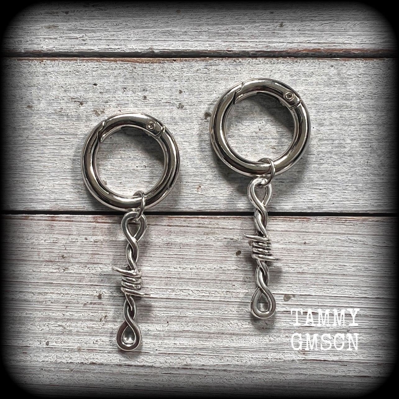 These punk rock boot charms feature antique silver barb wire charms, nice and lightweight, and nice and dangly 6cms from top to bottom.

Made to last, all our boot charms are made with super sturdy Rhodium snap rings and strong jump rings. They wont come off and they will not rust!