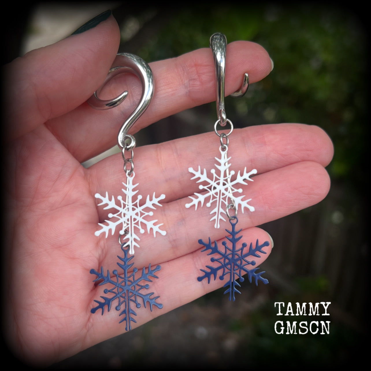 Featuring delicate white and navy blue snowflake charms, these earrings are super lightweight, weighing approx 4 grams each, and are lovely and dangly at just under 8cms from tip to tip.

This pair has been made on 6 gauge (4mm) surgical steel full curl hooks, suitable for stretched lobes.