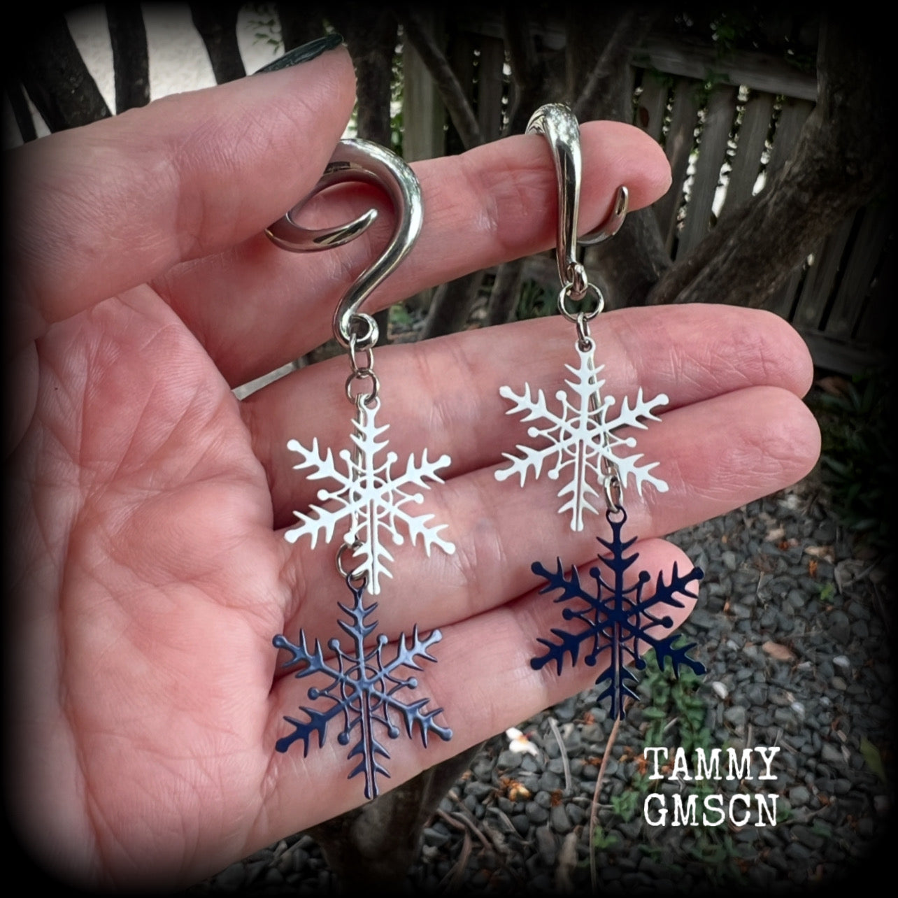 Featuring delicate white and navy blue snowflake charms, these earrings are super lightweight, weighing approx 4 grams each, and are lovely and dangly at just under 8cms from tip to tip.

This pair has been made on 6 gauge (4mm) surgical steel full curl hooks, suitable for stretched lobes.