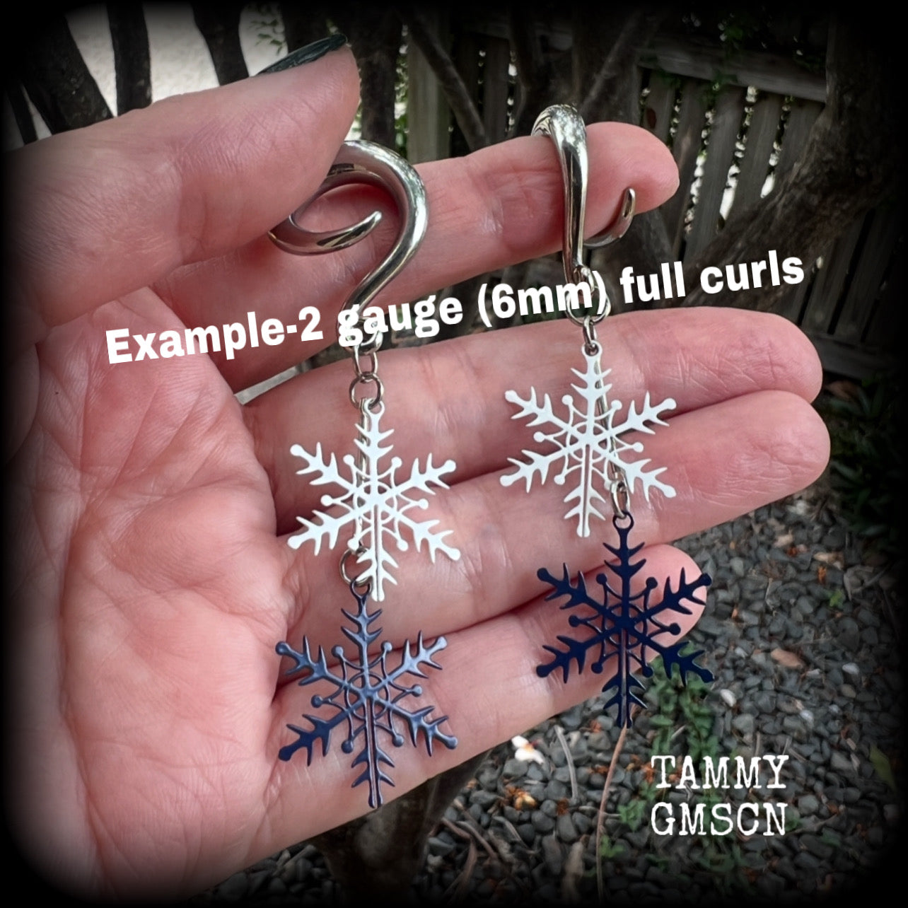 Featuring delicate white and navy blue snowflake charms, these earrings are super lightweight, weighing approx 4 grams each, and are lovely and dangly at just under 8cms from tip to tip.

This pair has been made on 6 gauge (4mm) surgical steel full curl hooks, suitable for stretched lobes.