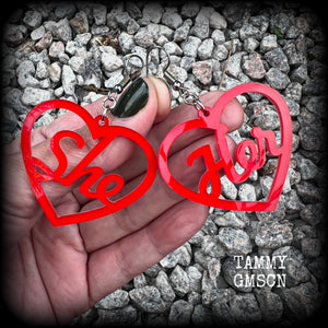 These earrings feature gorgeous bright red hearts showing the pronouns SHE/HER. 
These are nice and lightweight (at only a few grams each), and measure approx 6.5cms from tip to tip.

This pair have been made on stainless steel french hooks, for pierced ears.