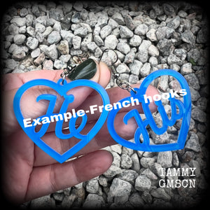 These awesome earrings feature gorgeous bright neon blue hearts showing the pronouns HE/HIS. 
These are nice and lightweight (at only a few grams each), and measure approx 6.5cms from tip to tip.

This pair have been made on stainless steel french hooks, for pierced ears.