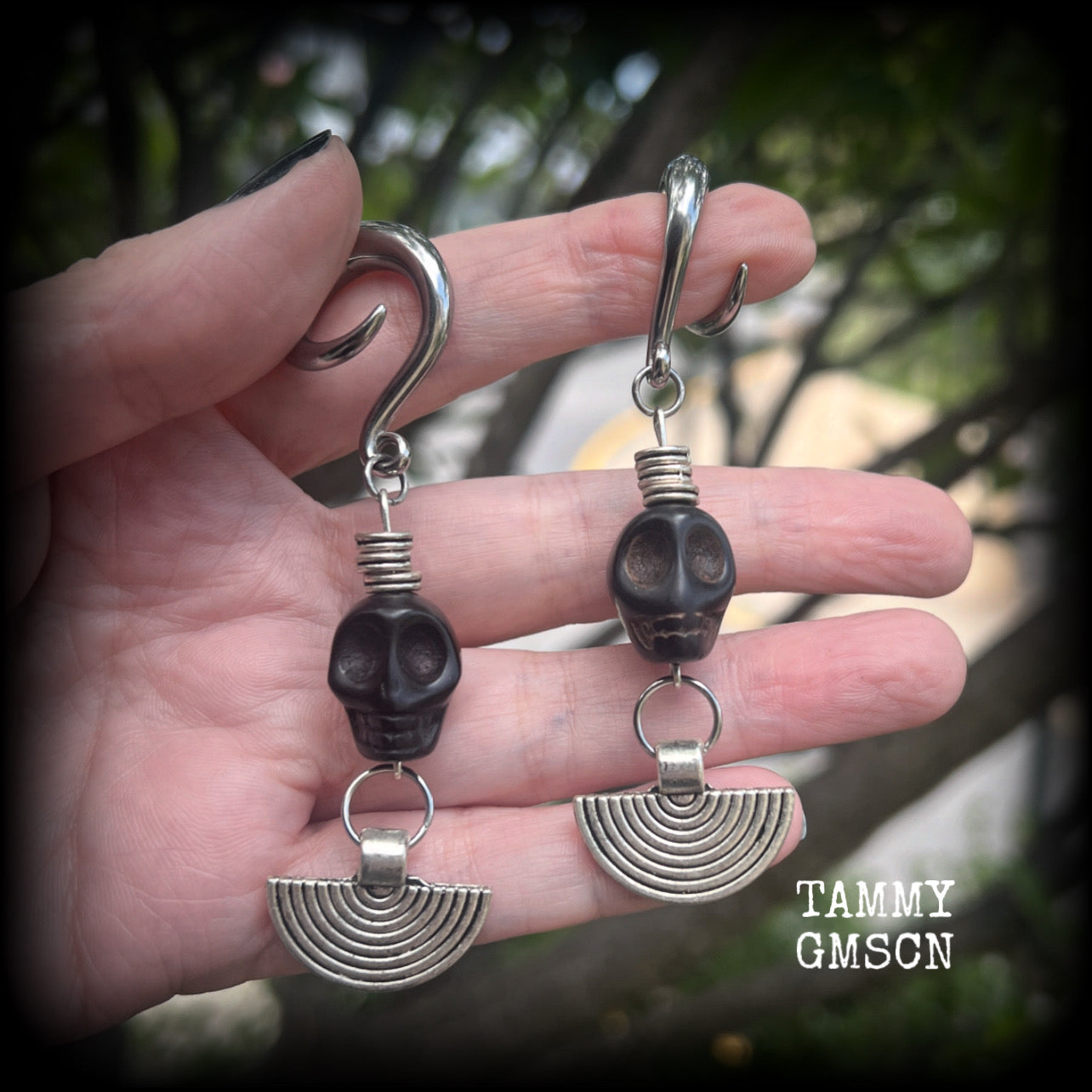 These gorgeous black stone skull and antique silver tribal gauged earrings measure just under 9cms from tip to tip and weigh in at 16 grams a piece.

This pair has been made on 2 gauge (6mm) surgical steel full curl hooks, to be worn in stretched lobes.