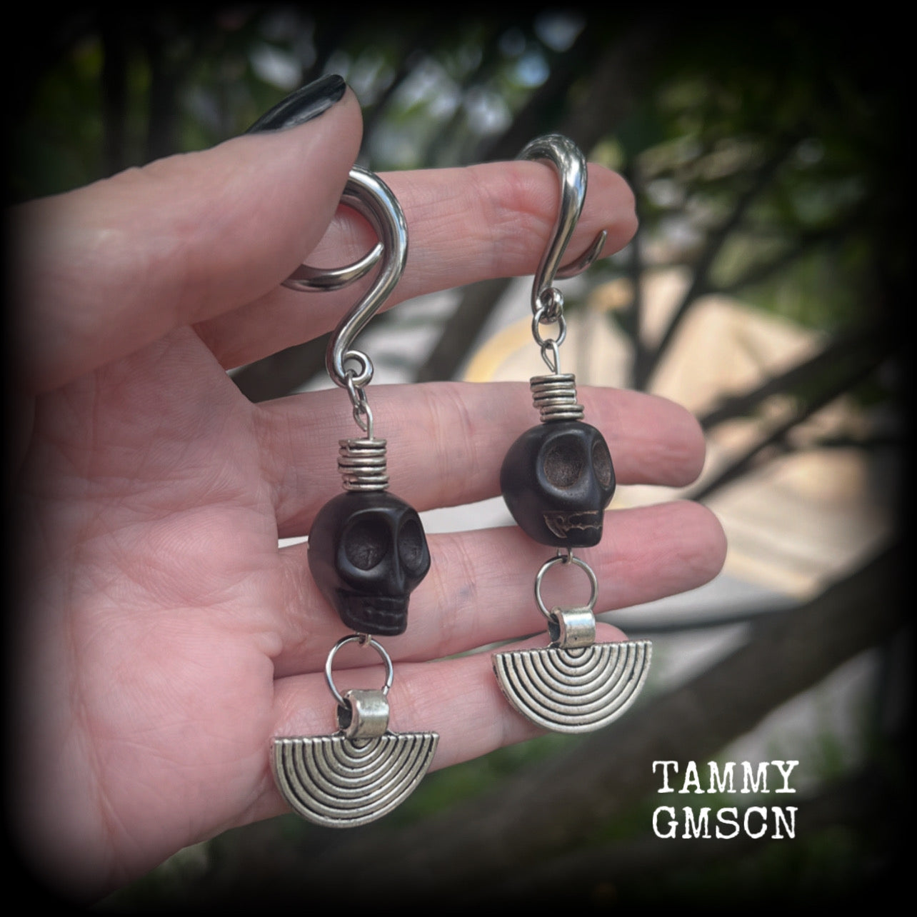 These gorgeous black stone skull and antique silver tribal gauged earrings measure just under 9cms from tip to tip and weigh in at 16 grams a piece.

This pair has been made on 2 gauge (6mm) surgical steel full curl hooks, to be worn in stretched lobes.