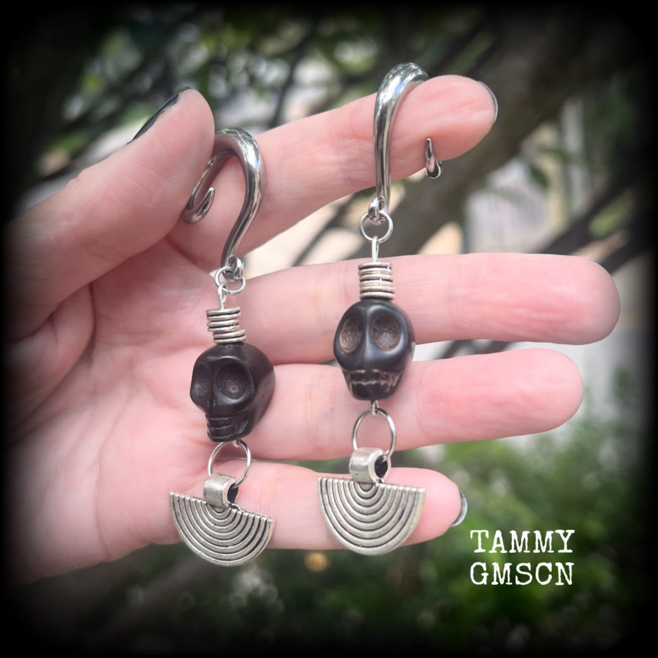 These gorgeous black stone skull and antique silver tribal gauged earrings measure just under 9cms from tip to tip and weigh in at 16 grams a piece.

This pair has been made on 2 gauge (6mm) surgical steel full curl hooks, to be worn in stretched lobes.