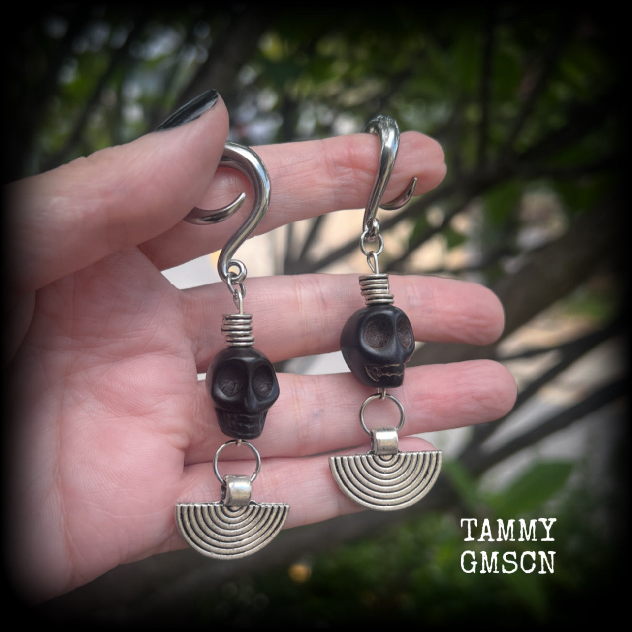 These gorgeous black stone skull and antique silver tribal gauged earrings measure just under 9cms from tip to tip and weigh in at 16 grams a piece.

This pair has been made on 2 gauge (6mm) surgical steel full curl hooks, to be worn in stretched lobes.