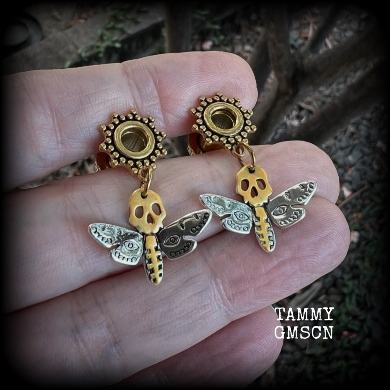 These unique tunnel earrings feature stunning antique silver and hand painted gold enamel deaths head moths, weighing only a few grams each, and measure approx 3cms from tip to tip.

This pair has been made on 2 gauge (6mm) ornate surgical steel screw fit tunnels.