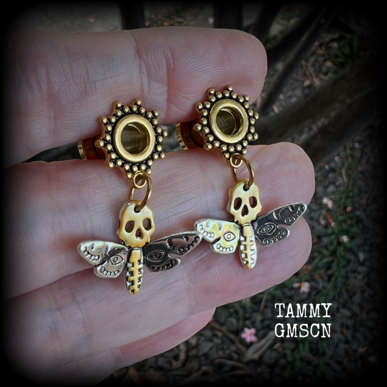 These unique tunnel earrings feature stunning antique silver and hand painted gold enamel deaths head moths, weighing only a few grams each, and measure approx 3cms from tip to tip.

This pair has been made on 2 gauge (6mm) ornate surgical steel screw fit tunnels.