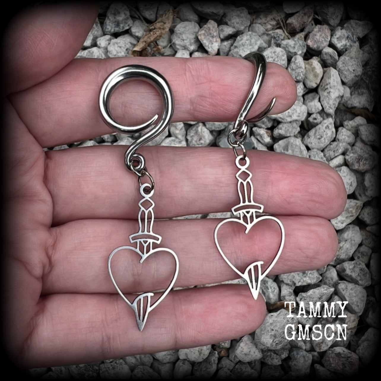 These awesome gauged earrings feature stainless steel heart and dagger charms, are nice and lightweight, weighing only 3 grams a piece, and nice and dangly at just on 6 cms from tip to tip.

This pair has been made on 6 gauge (4mm) surgical steel full curl hooks, suitable for stretched lobes.