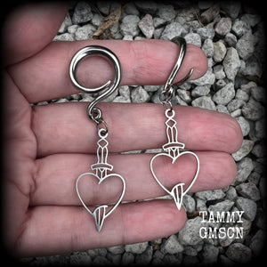 These awesome gauged earrings feature stainless steel heart and dagger charms, are nice and lightweight, weighing only 3 grams a piece, and nice and dangly at just on 6 cms from tip to tip.

This pair has been made on 6 gauge (4mm) surgical steel full curl hooks, suitable for stretched lobes.