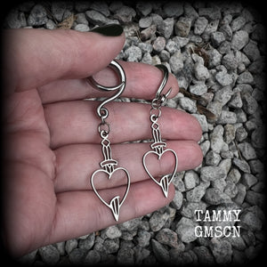 These awesome gauged earrings feature stainless steel heart and dagger charms, are nice and lightweight, weighing only 3 grams a piece, and nice and dangly at just on 6 cms from tip to tip.

This pair has been made on 6 gauge (4mm) surgical steel full curl hooks, suitable for stretched lobes.
