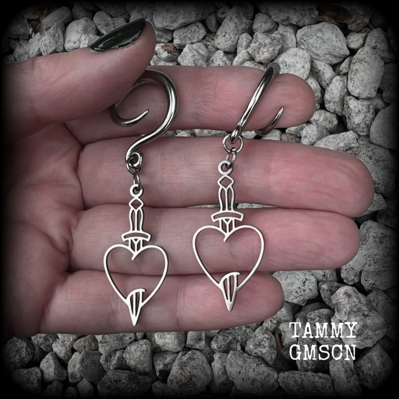 These awesome gauged earrings feature stainless steel heart and dagger charms, are nice and lightweight, weighing only 3 grams a piece, and nice and dangly at just on 6 cms from tip to tip.

This pair has been made on 6 gauge (4mm) surgical steel full curl hooks, suitable for stretched lobes.