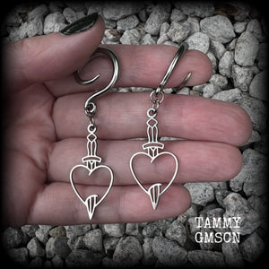 These awesome gauged earrings feature stainless steel heart and dagger charms, are nice and lightweight, weighing only 3 grams a piece, and nice and dangly at just on 6 cms from tip to tip.

This pair has been made on 6 gauge (4mm) surgical steel full curl hooks, suitable for stretched lobes.