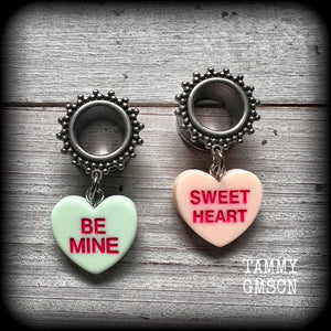 These adorable tunnel earrings feature cute candy hearts, are nice and lightweight, weighing only 6 grams each and measure just over 4cms from tip to tip.
This pair has been made with 1/2" (12mm) gauge ornate stainless steel screw fit tunnels.