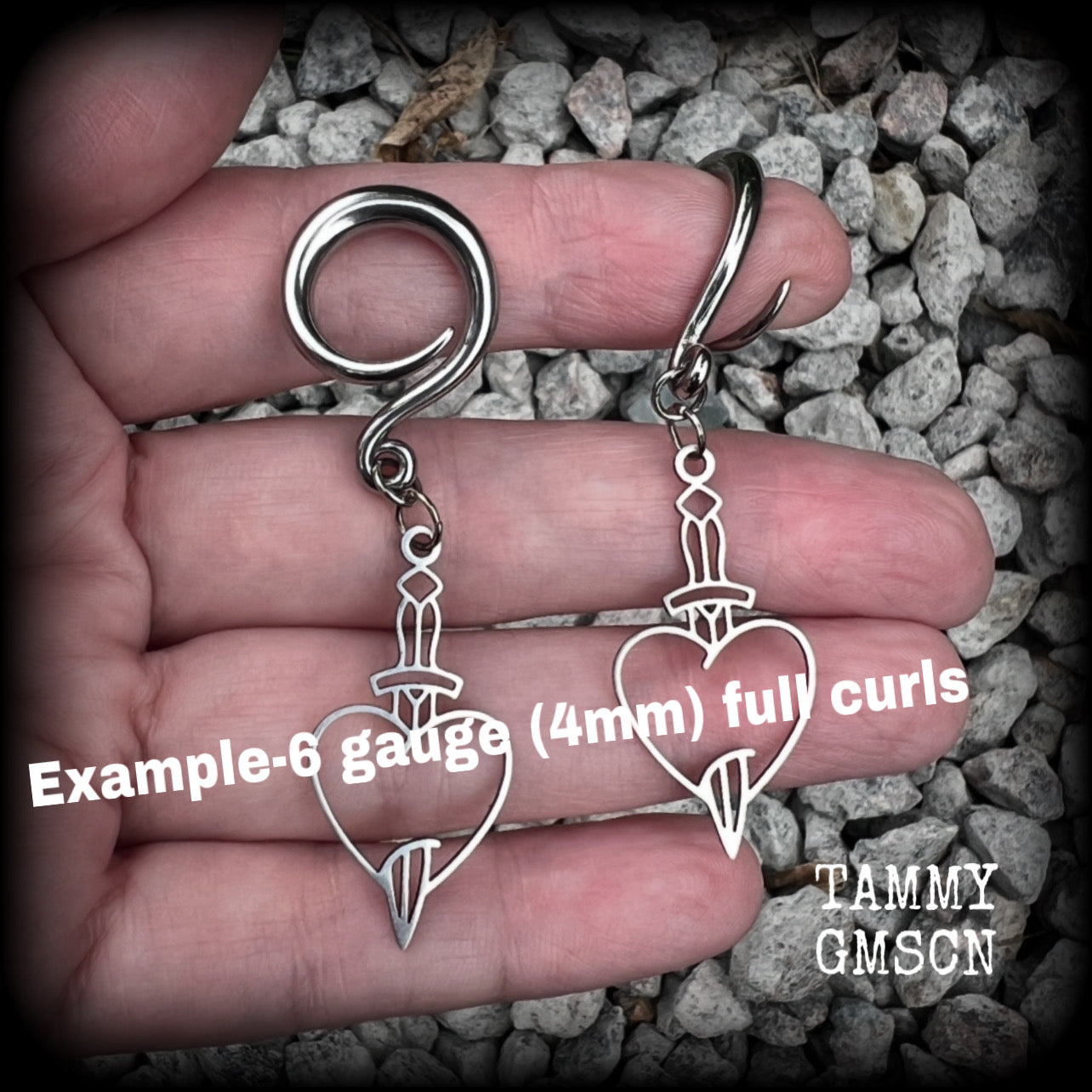 These awesome gauged earrings feature stainless steel heart and dagger charms, are nice and lightweight, weighing only 3 grams a piece, and nice and dangly at just on 6 cms from tip to tip.

This pair has been made on 6 gauge (4mm) surgical steel full curl hooks, suitable for stretched lobes.