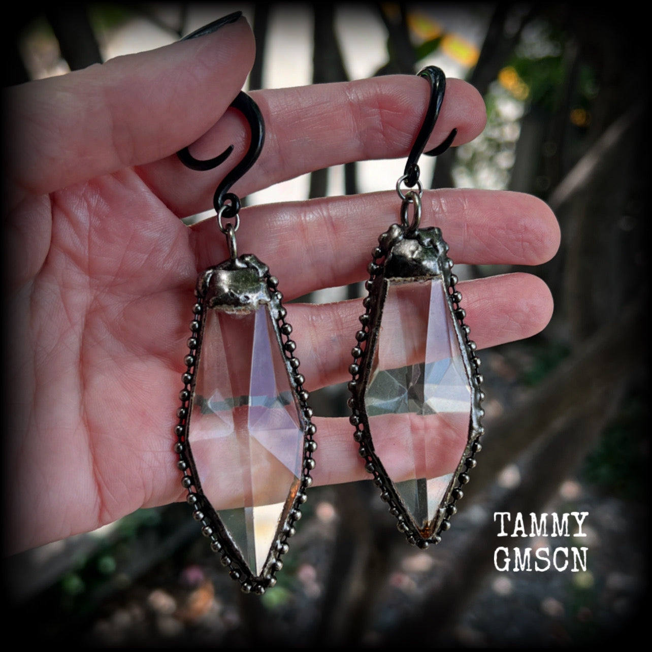 These gorgeous dangly gothic glass earrings have been made with gorgeous chunky faceted clear glass pieces, measuring just on 10 cms from tip to tip, and weighing approx 24 grams each.

These earrings have been made on 6 gauge (4mm) surgical steel full curls, to be worn in stretched lobes.