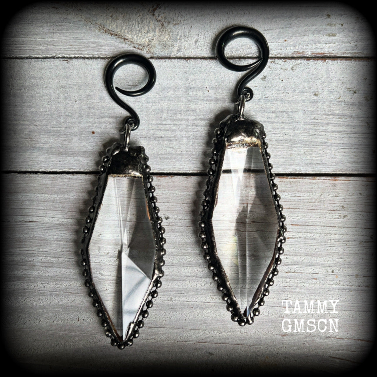 These gorgeous dangly gothic glass earrings have been made with gorgeous chunky faceted clear glass pieces, measuring just on 10 cms from tip to tip, and weighing approx 24 grams each.

These earrings have been made on 6 gauge (4mm) surgical steel full curls, to be worn in stretched lobes.