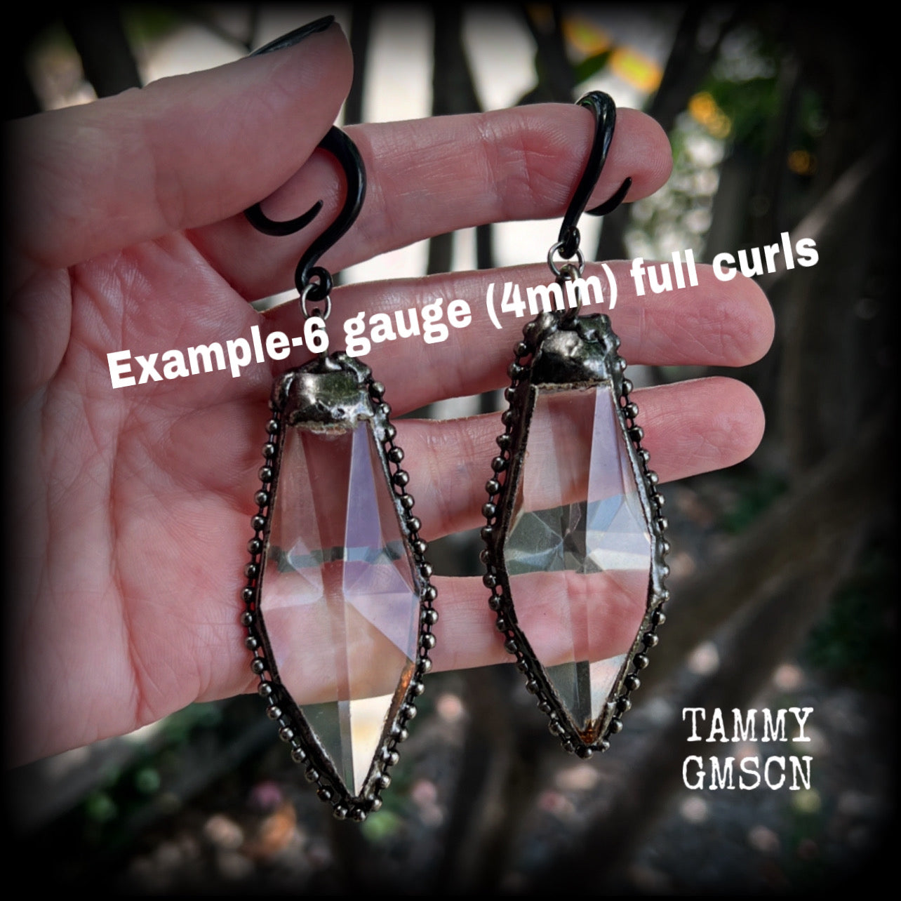 These gorgeous dangly gothic glass earrings have been made with gorgeous chunky faceted clear glass pieces, measuring just on 10 cms from tip to tip, and weighing approx 24 grams each.

These earrings have been made on 6 gauge (4mm) surgical steel full curls, to be worn in stretched lobes.