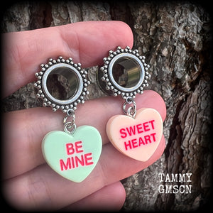 These adorable tunnel earrings feature cute candy hearts, are nice and lightweight, weighing only 6 grams each and measure just over 4cms from tip to tip.
This pair has been made with 1/2 (12mm) gauge ornate stainless steel screw fit tunnels.
