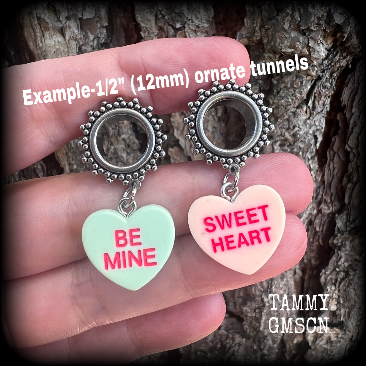 These adorable tunnel earrings feature cute candy hearts, are nice and lightweight, weighing only 6 grams each and measure just over 4cms from tip to tip.
This pair has been made with 1/2 (12mm) gauge ornate stainless steel screw fit tunnels.