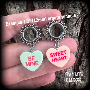 These adorable tunnel earrings feature cute candy hearts, are nice and lightweight, weighing only 6 grams each and measure just over 4cms from tip to tip.
This pair has been made with 1/2 (12mm) gauge ornate stainless steel screw fit tunnels.