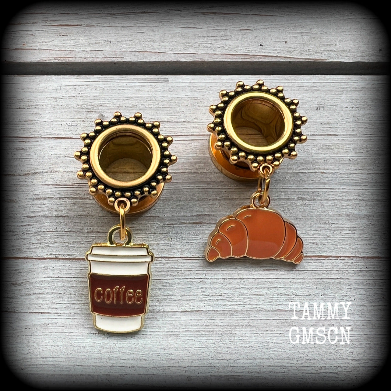 These adorable tunnel earrings feature a cup of coffee and a cute croissant, weighing approx 5 grams each, and measuring just under 4cms from tip to tip.

This pair has been made with 00 gauge (10mm) surgical steel ornate screw fit tunnels-suitable for pierced ears.