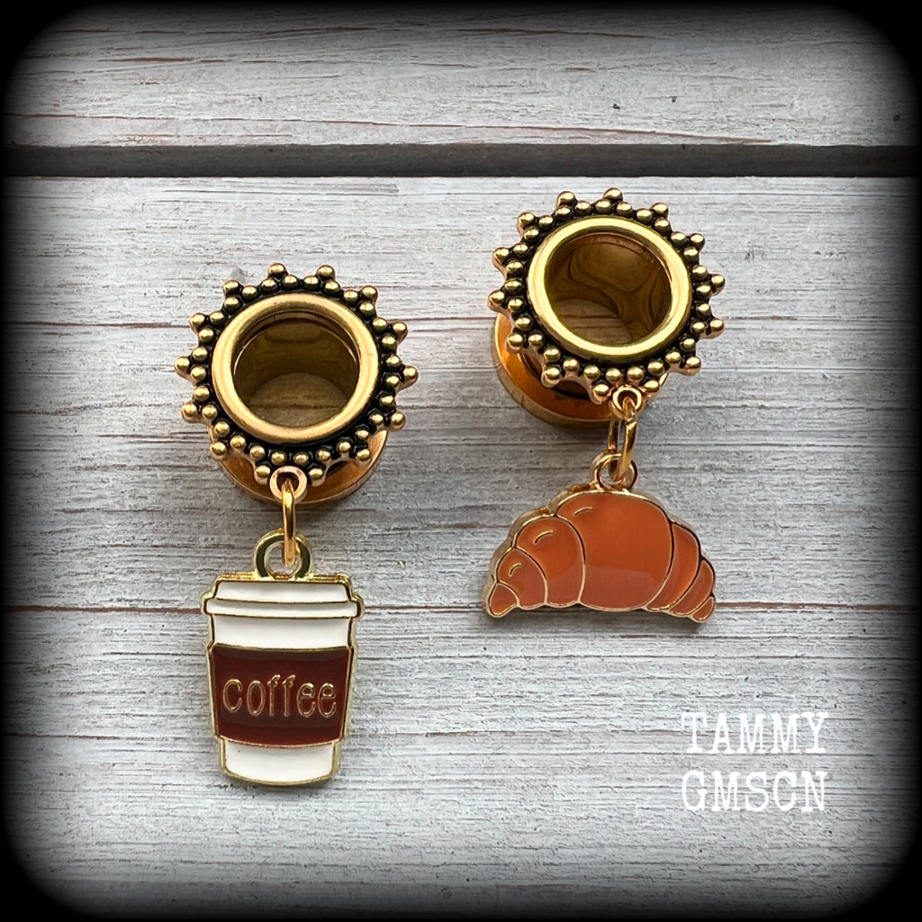 These adorable tunnel earrings feature a cup of coffee and a cute croissant, weighing approx 5 grams each, and measuring just under 4cms from tip to tip.

This pair has been made with 00 gauge (10mm) surgical steel ornate screw fit tunnels-suitable for pierced ears.
