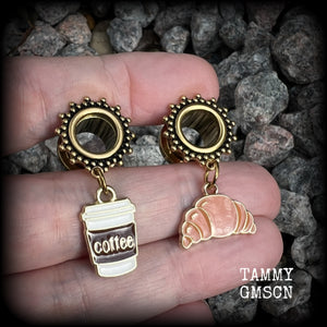 These adorable tunnel earrings feature a cup of coffee and a cute croissant, weighing approx 5 grams each, and measuring just under 4cms from tip to tip.

This pair has been made with 00 gauge (10mm) surgical steel ornate screw fit tunnels-suitable for pierced ears.