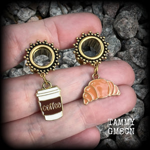 These adorable tunnel earrings feature a cup of coffee and a cute croissant, weighing approx 5 grams each, and measuring just under 4cms from tip to tip.

This pair has been made with 00 gauge (10mm) surgical steel ornate screw fit tunnels-suitable for pierced ears.