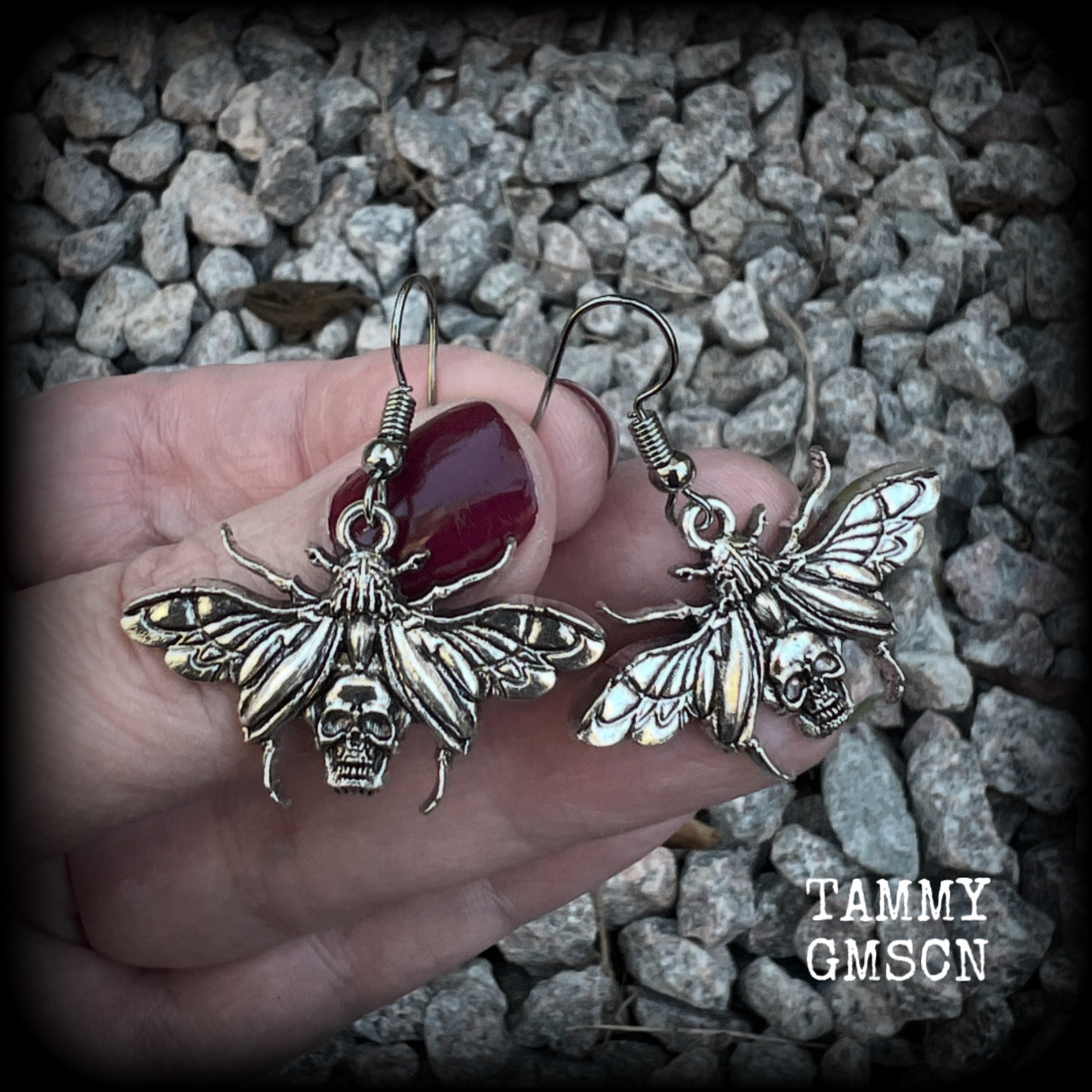 These awesome earrings feature antique silver scarab beetles with wings open revealing a skull on its body, measuring just under 4cms, and weighing only a few grams each.

This pair has been made on stainless steel french hooks, for pierced ears.
