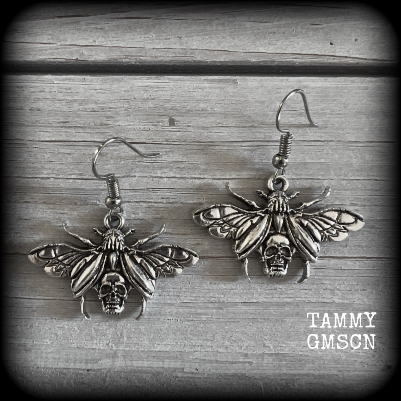 These awesome earrings feature antique silver scarab beetles with wings open revealing a skull on its body, measuring just under 4cms, and weighing only a few grams each.

This pair has been made on stainless steel french hooks, for pierced ears.