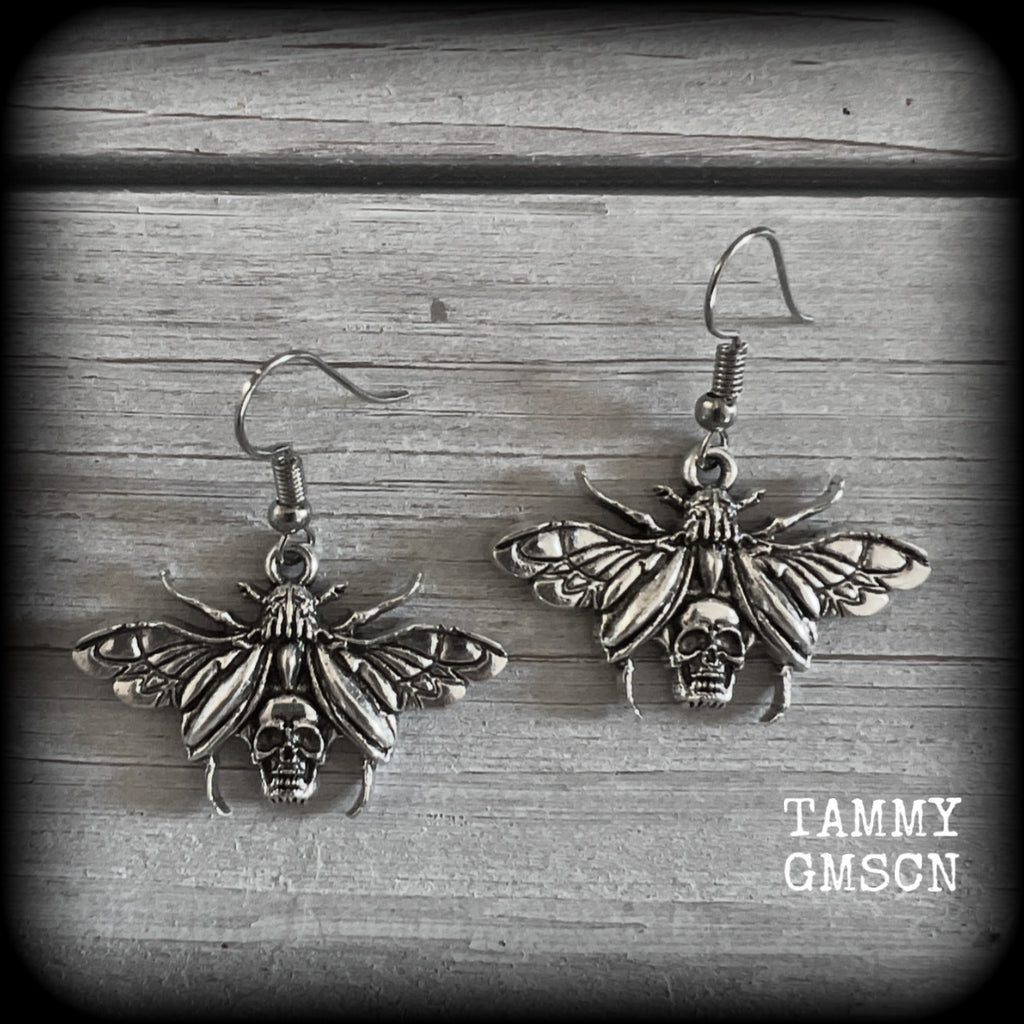 These awesome earrings feature antique silver scarab beetles with wings open revealing a skull on its body, measuring just under 4cms, and weighing only a few grams each.

This pair has been made on stainless steel french hooks, for pierced ears.