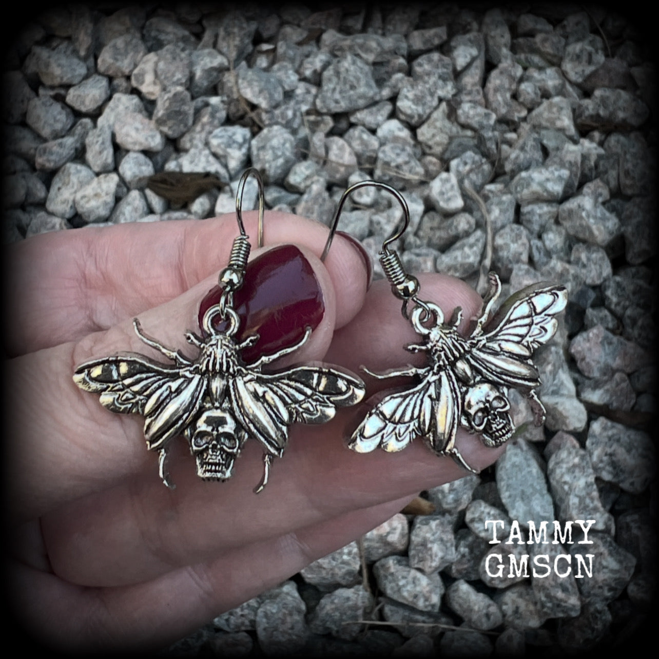 These awesome earrings feature antique silver scarab beetles with wings open revealing a skull on its body, measuring just under 4cms, and weighing only a few grams each.

This pair has been made on stainless steel french hooks, for pierced ears.