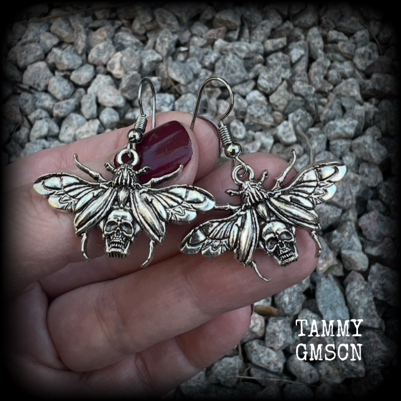 These awesome earrings feature antique silver scarab beetles with wings open revealing a skull on its body, measuring just under 4cms, and weighing only a few grams each.

This pair has been made on stainless steel french hooks, for pierced ears.