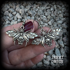 These awesome earrings feature antique silver scarab beetles with wings open revealing a skull on its body, measuring just under 4cms, and weighing only a few grams each.

This pair has been made on stainless steel french hooks, for pierced ears.