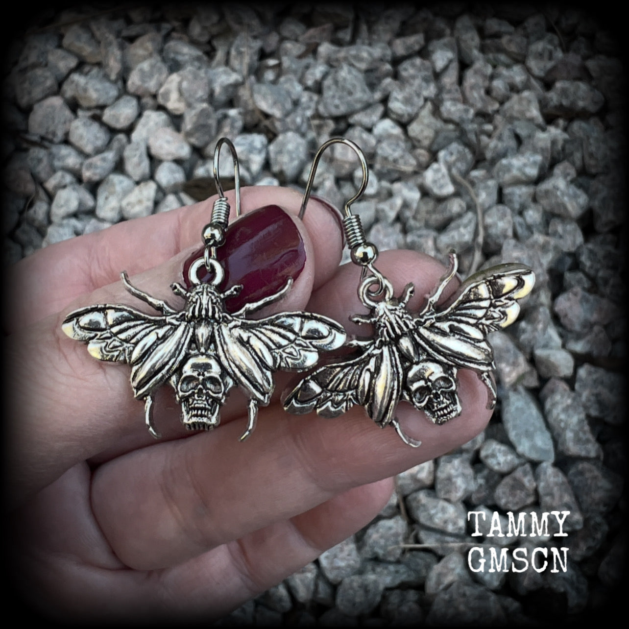 These awesome earrings feature antique silver scarab beetles with wings open revealing a skull on its body, measuring just under 4cms, and weighing only a few grams each.

This pair has been made on stainless steel french hooks, for pierced ears.