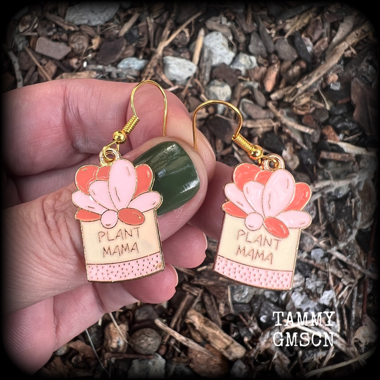 These quirky earrings feature an antique gold and enamel potted ‘PLANT MAMA’ plant, measuring just on 5cms from top to bottom, and weighing only a few grams each.
This pair has been made on antique gold french hooks, suitable for pierced ears.