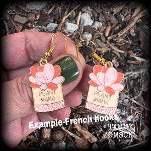 These quirky earrings feature an antique gold and enamel potted ‘PLANT MAMA’ plant, measuring just on 5cms from top to bottom, and weighing only a few grams each.
This pair has been made on antique gold french hooks, suitable for pierced ears.