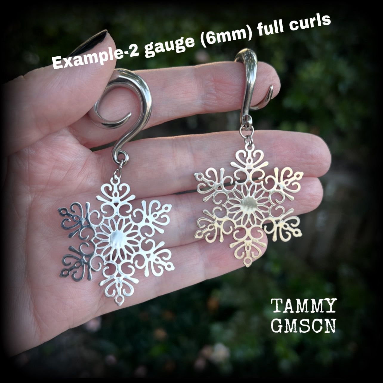 Featuring delicate stainless steel snowflake charms, these gorgeous earrings weigh approx 8 grams each, and are lovely and dangly at just over 7cms from tip to tip.

This pair has been made on 2 gauge (6mm) surgical steel full curl hooks, suitable for stretched lobes.
