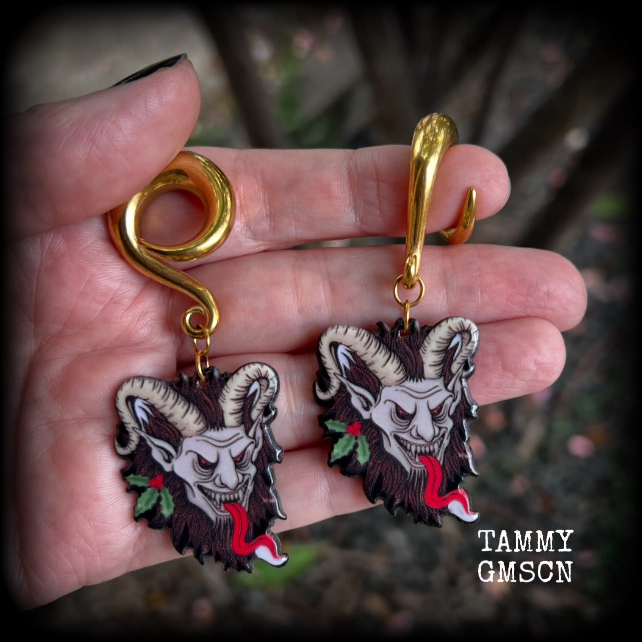 Featuring a festive horned Krampus nestled in  sprigs of holly, these acrylic earrings are lightweight, weighing approx 16 grams each and are nice and dangly, measuring just on 7.5cms cms from tip to tip. 

This pair has been made on surgical steel 0 gauge (8mm) full curls, suitable for stretched lobes.