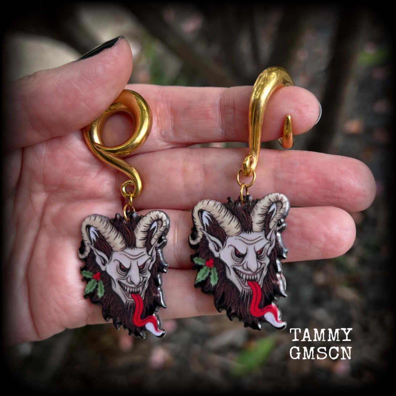 Featuring a festive horned Krampus nestled in  sprigs of holly, these acrylic earrings are lightweight, weighing approx 16 grams each and are nice and dangly, measuring just on 7.5cms cms from tip to tip. 

This pair has been made on surgical steel 0 gauge (8mm) full curls, suitable for stretched lobes.