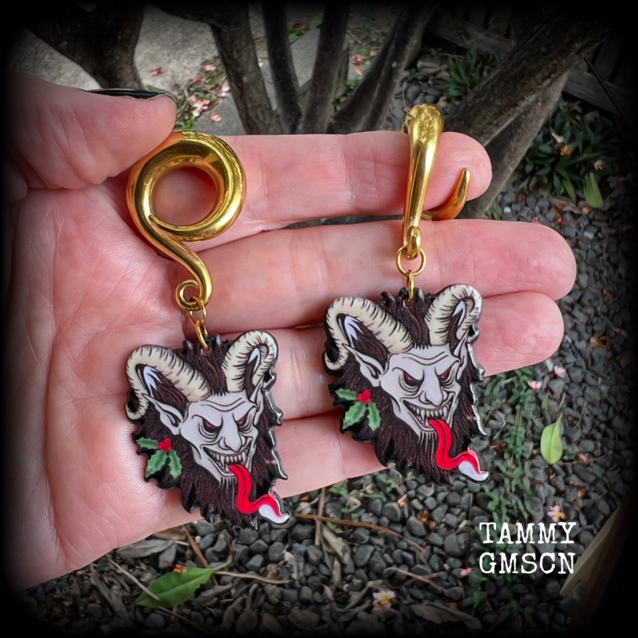 Featuring a festive horned Krampus nestled in  sprigs of holly, these acrylic earrings are lightweight, weighing approx 16 grams each and are nice and dangly, measuring just on 7.5cms cms from tip to tip. 

This pair has been made on surgical steel 0 gauge (8mm) full curls, suitable for stretched lobes.