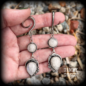 These gorgeous earrings feature polished Rainbow Moonstone gemstones in a beautiful boho antique silver setting, lovely and dangly at approx 8cms from tip to tip, and not too heavy at 9 grams each.
This pair had been made on 6 gauge (4mm) surgical steel full curl hooks, to be worn in stretched lobes.