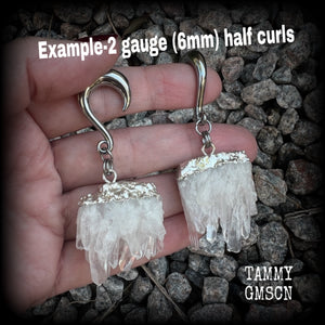 These gorgeous gauged earrings feature beautiful raw clear quartz pieces, measuring just under 7cms from tip to tip, and weighing approx 30 grams each.

This pair has been made on 2 gauge (6mm) surgical steel half curl hooks, suitable for stretched lobes.