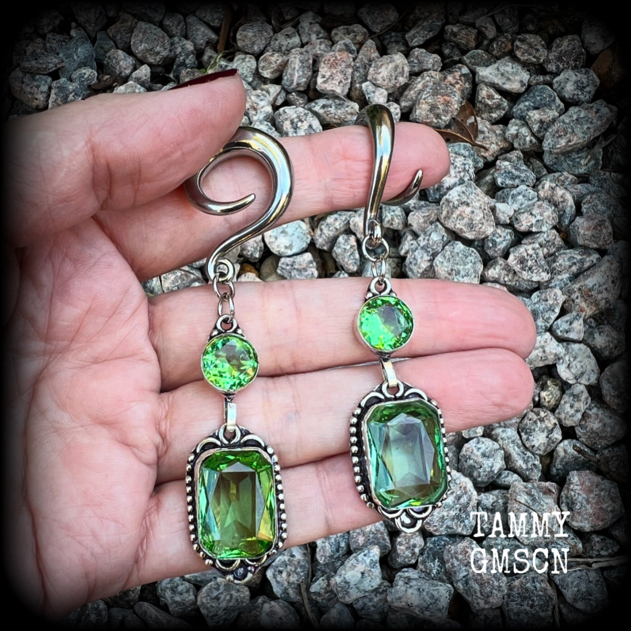 This pair of beautifully dangly earrings features gorgeous green peridot gemstones in a boho antique silver setting, weighing approx 14 grams a piece and measuring just on 8.5cms from tip to tip.

This pair have been made on 2 gauge (6mm) surgical steel full curl hooks, to be worn in stretched lobes.
